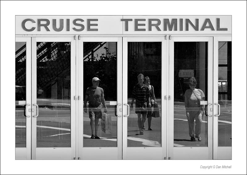 CruiseTerminal2006|07|17: Cruise Terminal. San Francisco, California. July 17, 2006. &copy; Copyright G Dan Mitchell.    keywords: cruise terminal ferry building san francisco california reflections of people in door windows black and white photograph