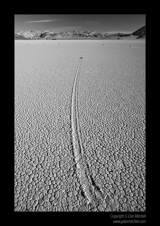 CurvingTrack2007|04|03: Curving Track, Racetrack Playa. Death Valley National Park, California. April 3, 2007. &copy; "Copyright G Dan Mitchell". ("sales")    keywords: moving rocks curving track racetrack play death valley national park california black and white photograph