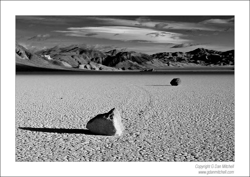 RacetrackTwoRocksBW2006|04|03: Two Rocks, Racetrack Playa. Death Valley National Park. April 3, 2006. &copy; "Copyright G Dan Mitchell". ("sales")    keywords: race track playa two rocks death valley national park dawn clouds california black and white photograph