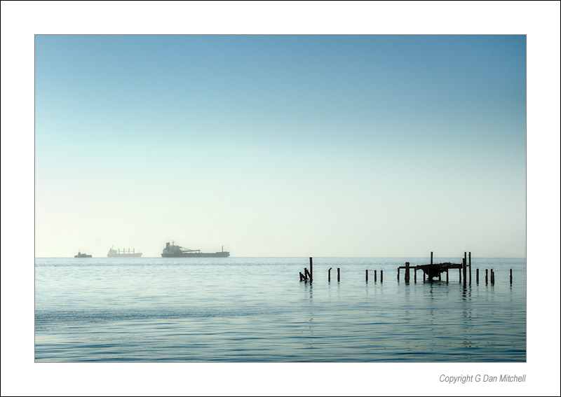 SFBayMorningShips2006|07|17: Three Ships at Anchor. San Francisco, California. July 17, 2006. &copy; Copyright G Dan Mitchell.    keywords: three ships at anchor san francisco bay california morning pier pilings color photograph