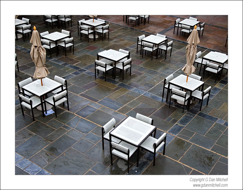 UCLAPatioRain2007|01|27: Patio and Rain. University of California, Los Angeles. January 27, 2007. &copy; "Copyright G Dan Mitchell". ("sales")    keywords: white tables chairs patio rain wet stone floor ucla university of california los angeles black and white photograph