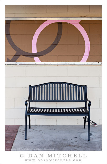 Bench and Cinder Block Wall Bench and Cinder Block Wall - A bench, chained to the sidewalk, in front of a cinder block wall with male/female symbols.