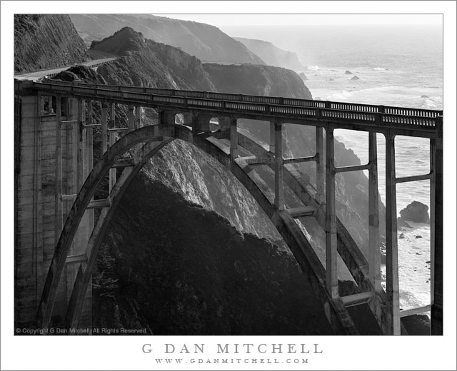 Bixby Bridge, Pacific Coast Highway - Black and white photograph of the Pacific Coast Highway crossing Bixby Bridge above the rugged Big Sur coastline of California.