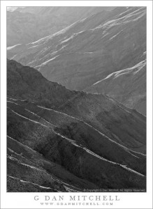 Morning light angles across eroded ridges and gullies on lower slopes of the Panamint Range above Trail Canyon, Death Valley National Park.